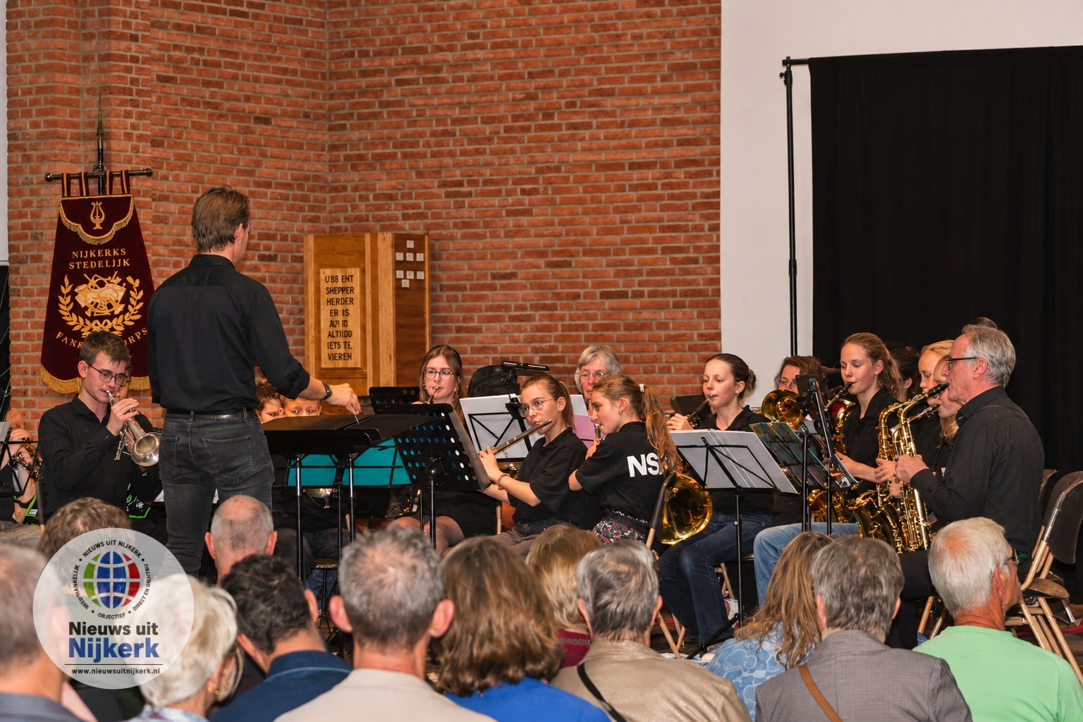 Helder fanfareconcert in bakstenen zaal.png